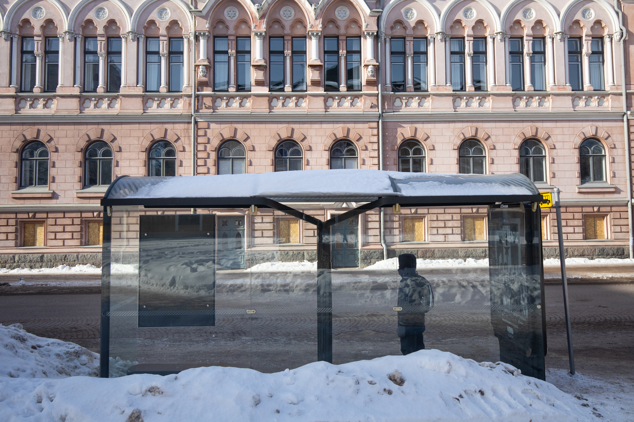 A passenger waiting at a bus stop.